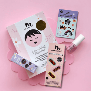 pink kids makeup set with accessories on pink background