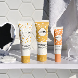 Three MEBEME skincare products on a bathroom shelf with a tiled wall background.