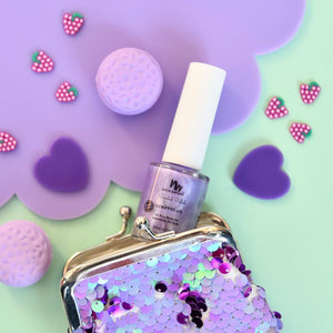 purple kids nail polish coming out of a purple coin purse