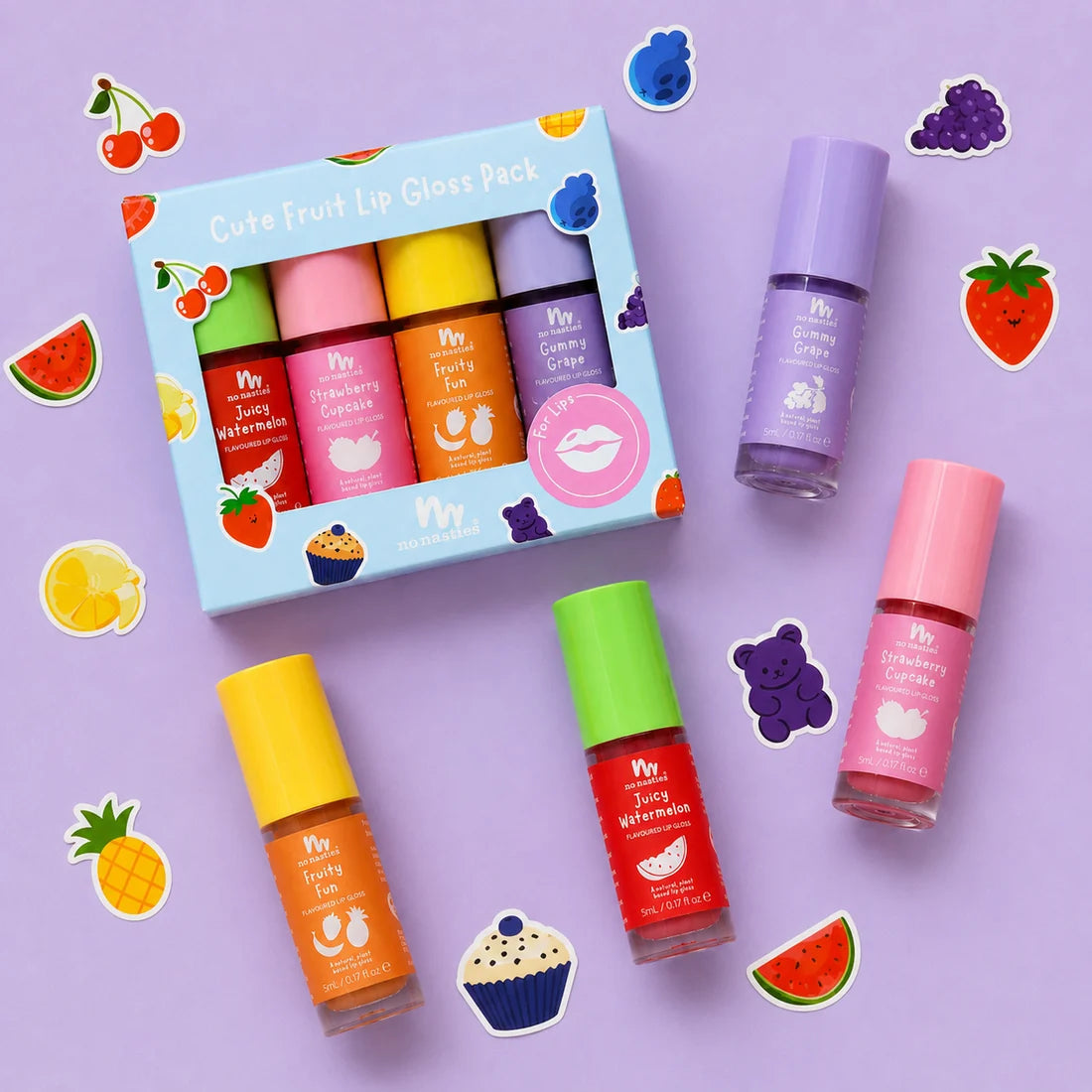 A fruit- hemed lip gloss set displayed on a lavender background with decorative fruit stickers. The set includes a light blue box labeled 'Cute Fruit Lip Gloss Pack' and four individual tubes of lip gloss in pink, purple, orange, and red, each with a matching coloured cap.