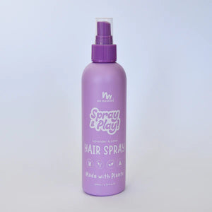 Purple hair spray bottle with 'Spray & Play' text on a light purple background