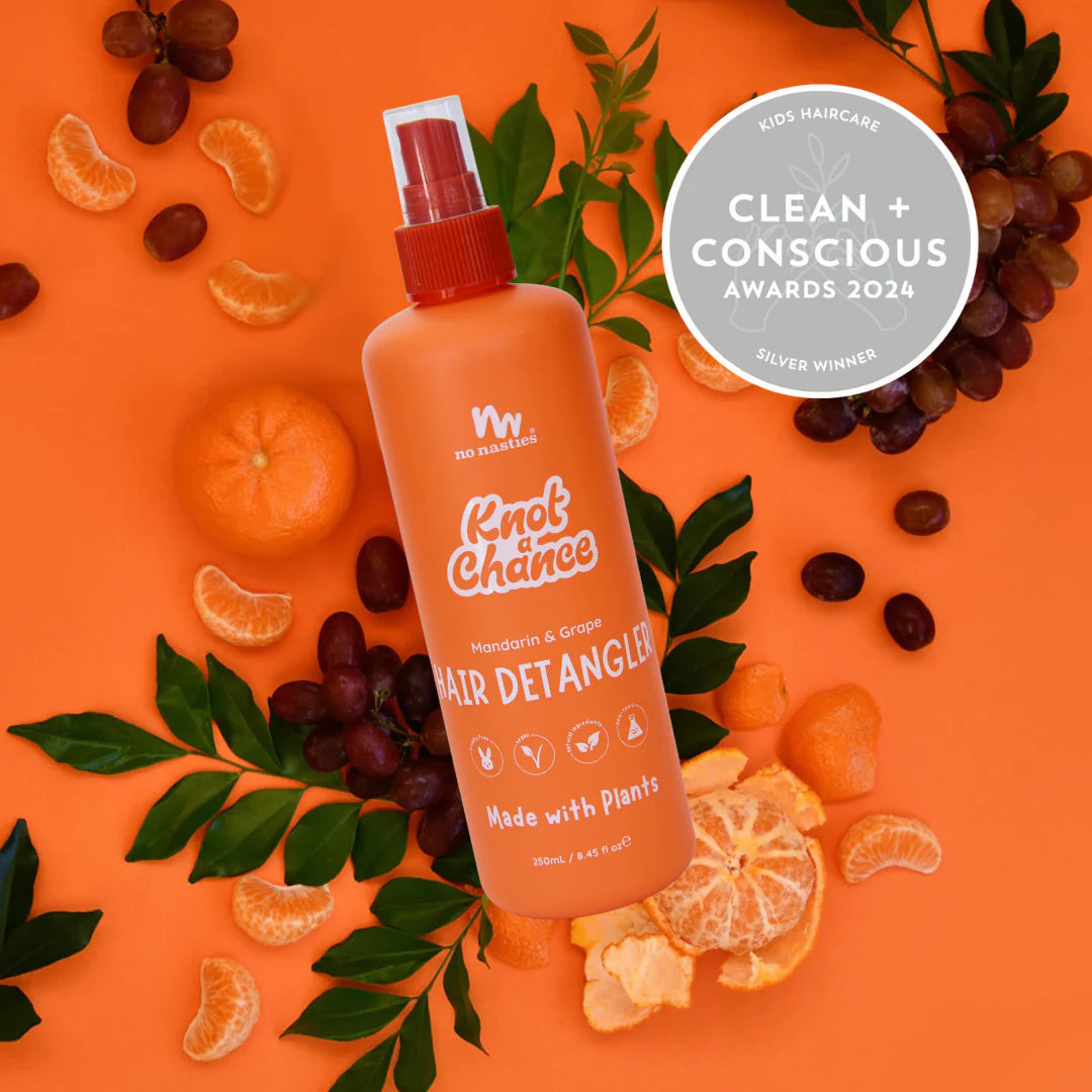 No Nasties Kids Natrual Detangler Spray on an orange background with mandarins and grapes