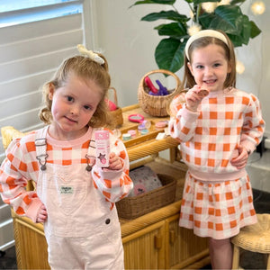 little girls holding pink nail polish and eco blush