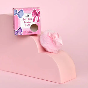Pink powder puff with packaging on a pink background