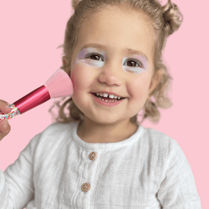 little-girl-putting-on-makeup-with-pink-brushes