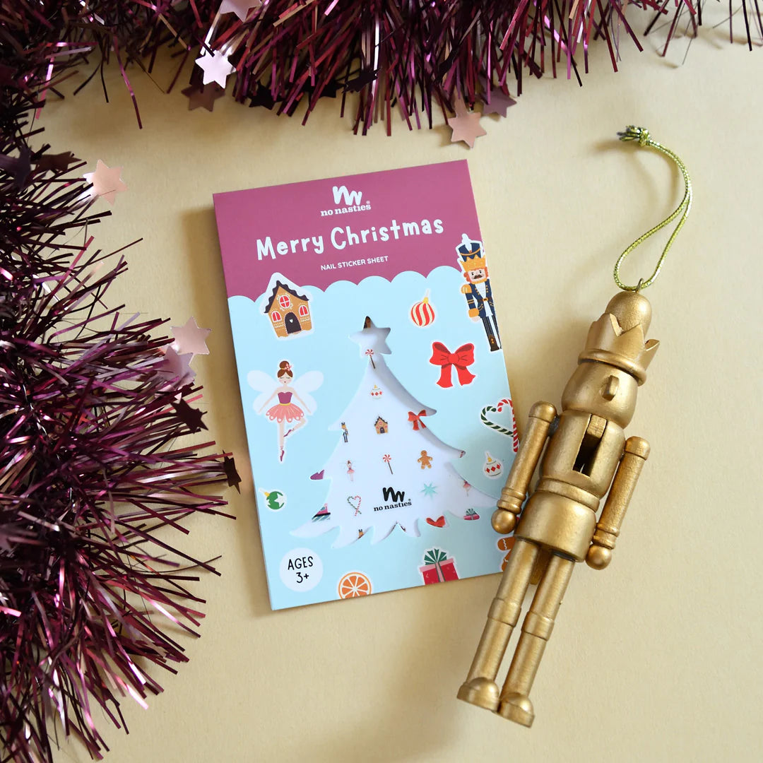 Christmas inspired nail stickers for kids on cream background with Christmas decorations