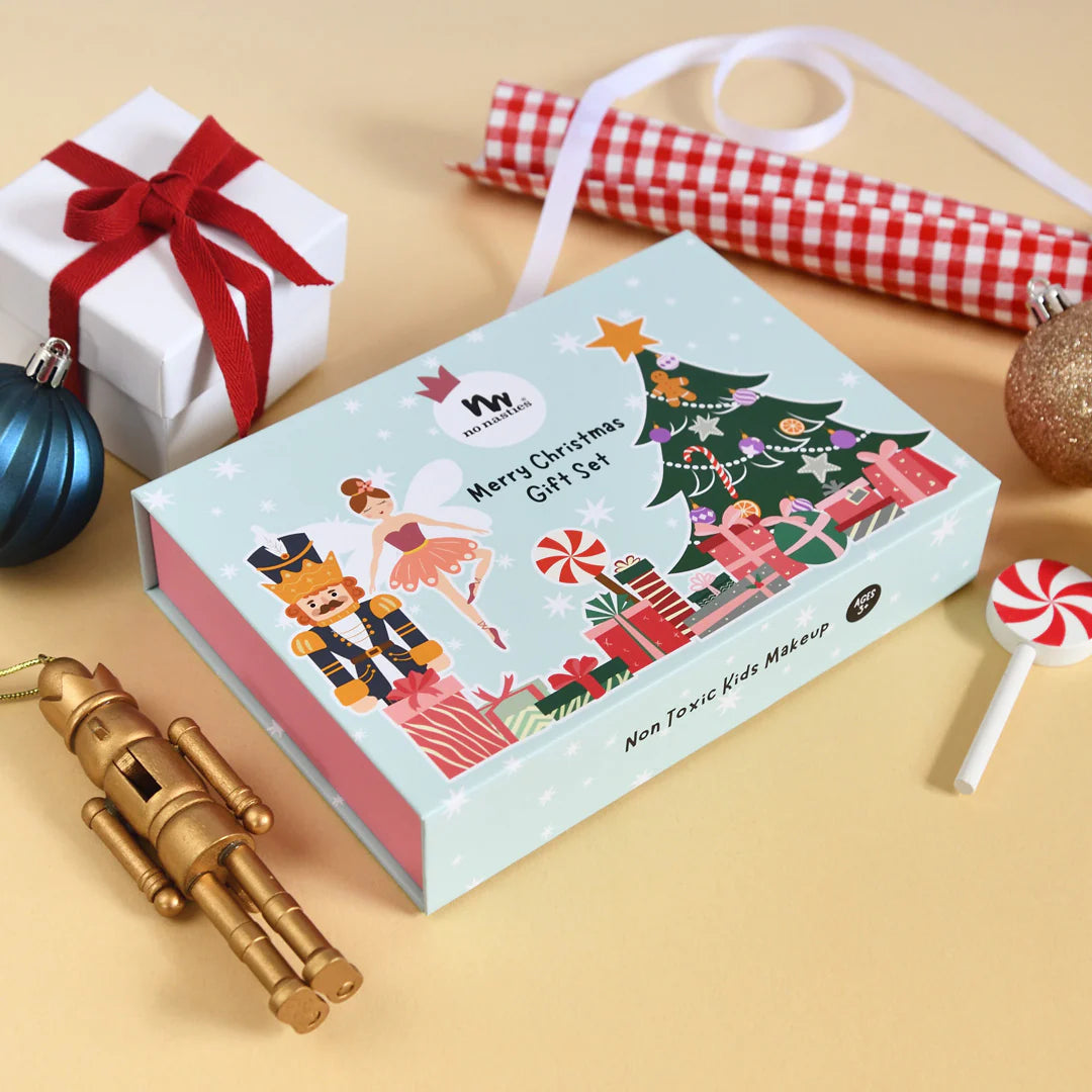 Christmas-themed Kids makeup gift set box with decorative items on a beige surface