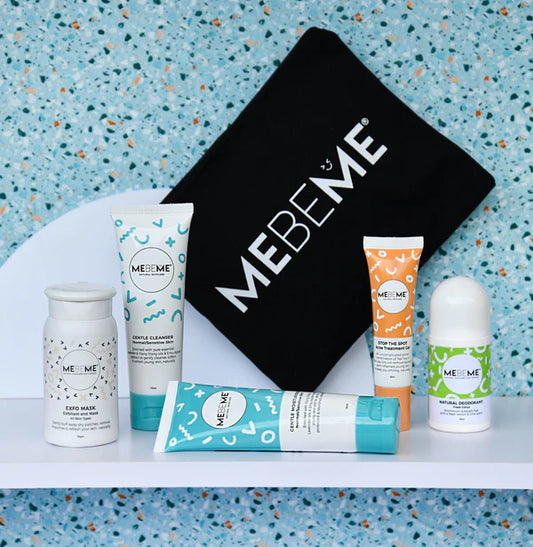 MEBEME skincare products including bottles and a roller on a white surface with a terrazzo patterned wall in the background.