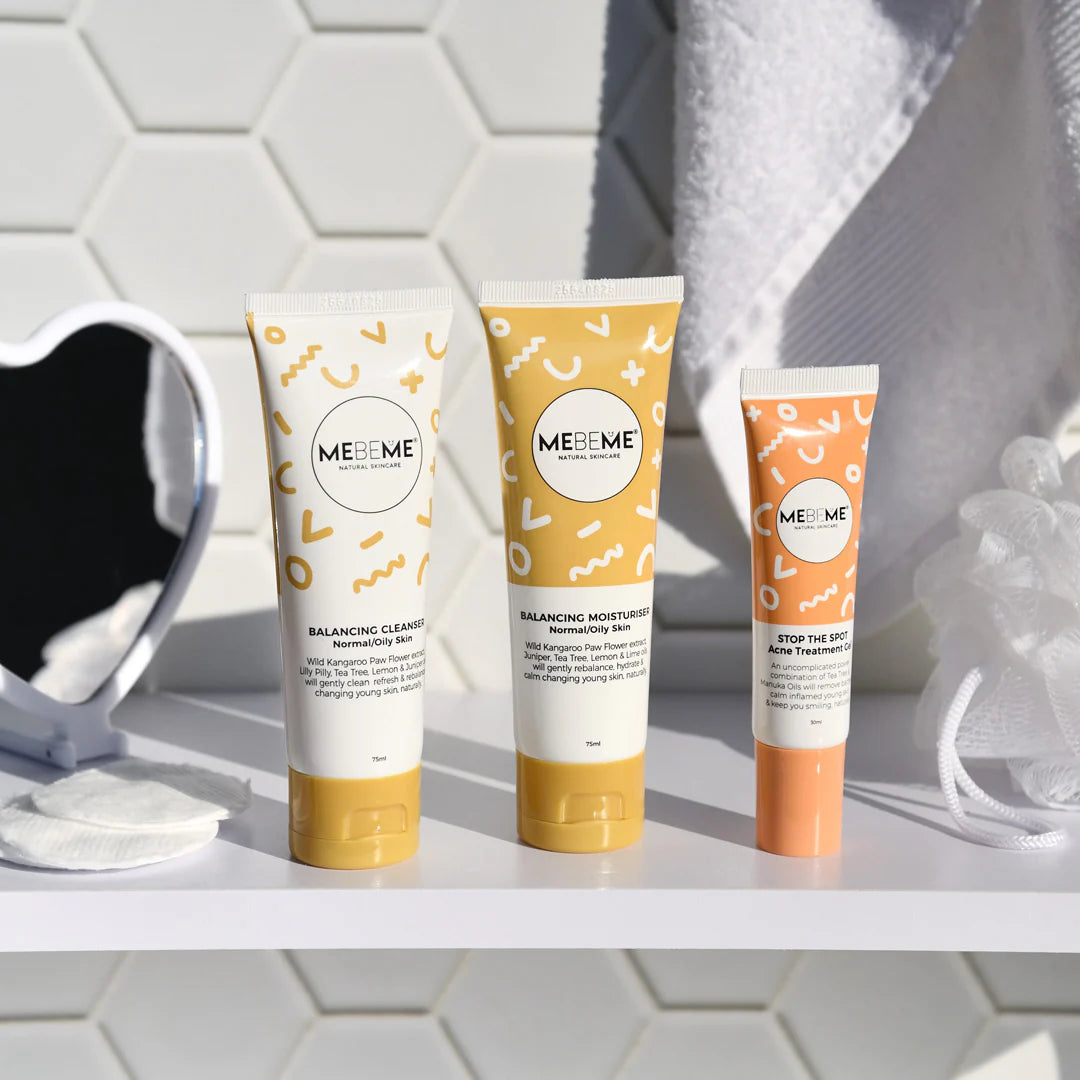 Three MEBEME skincare products on a bathroom shelf with a tiled wall background.