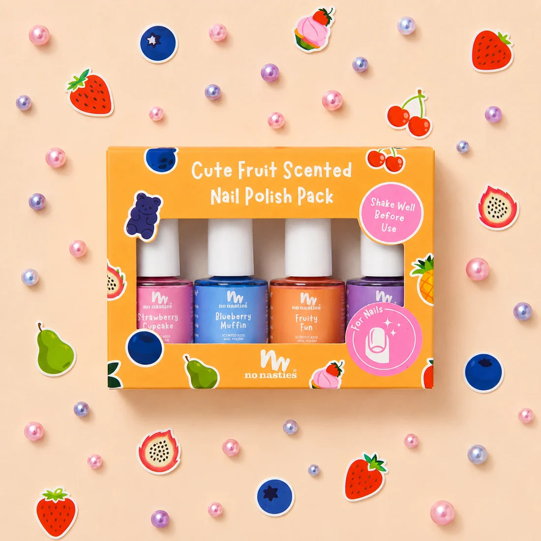 Cute ornage fruit scented kids nail polish set with four colours, pink, blue, peach and purple with fruit cut outs on a cream back ground 
