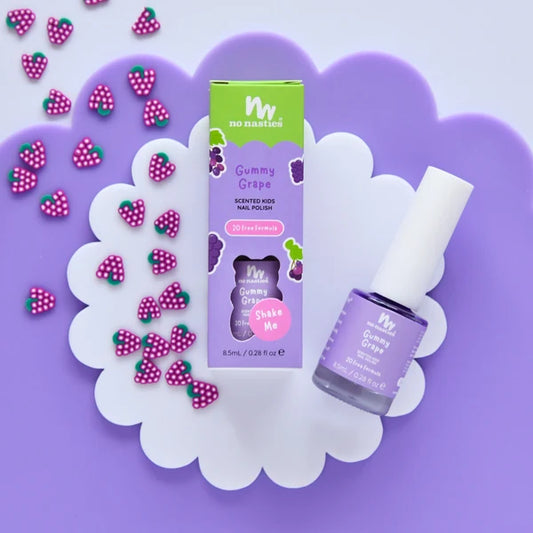 purple kids nail polish on purple and white back ground with little grape buttons