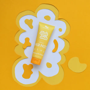 Hair paste tube on a decorative white and yellow background