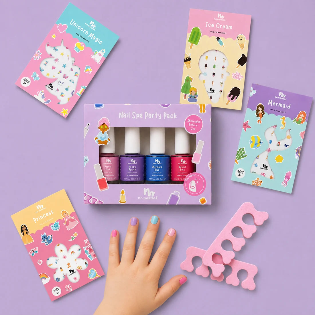 picture of little girls hand on purple background with nail stickers, nail polish and nail seperators