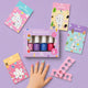 picture of little girls hand on purple background with nail stickers, nail polish and nail seperators