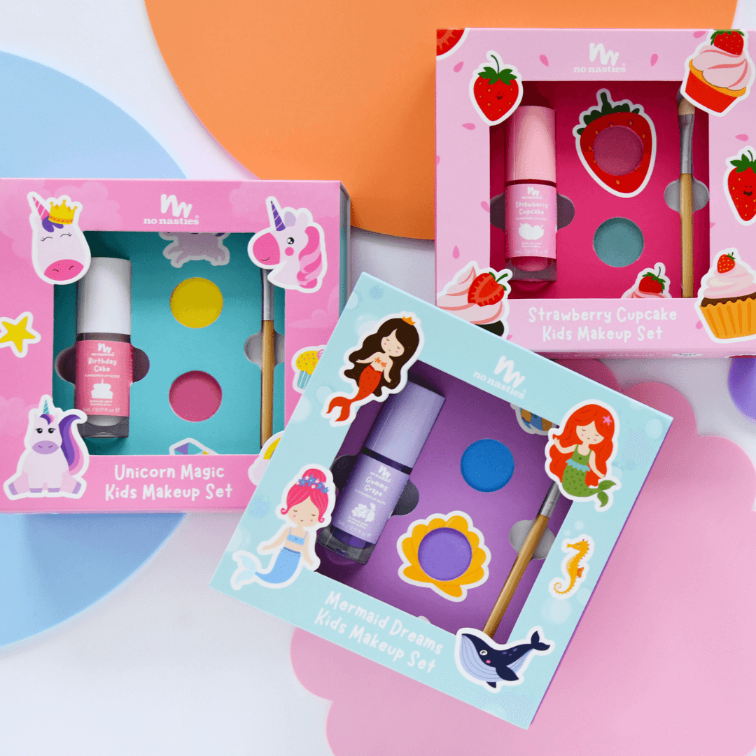 Children&#39;s makeup sets with colorful packaging on a multicolored background