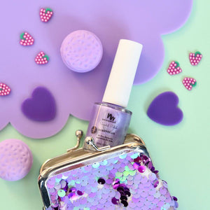 purple kids nail polish coming out of a purple coin purse 