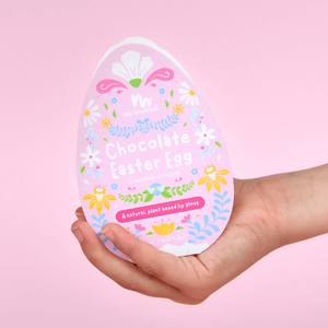 An easter egg being held in a girls hand