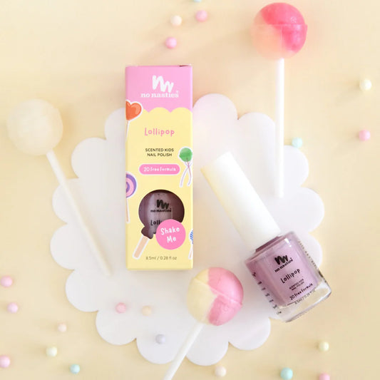 Nail polish with packaging and lollipop decorations on a light yellow background