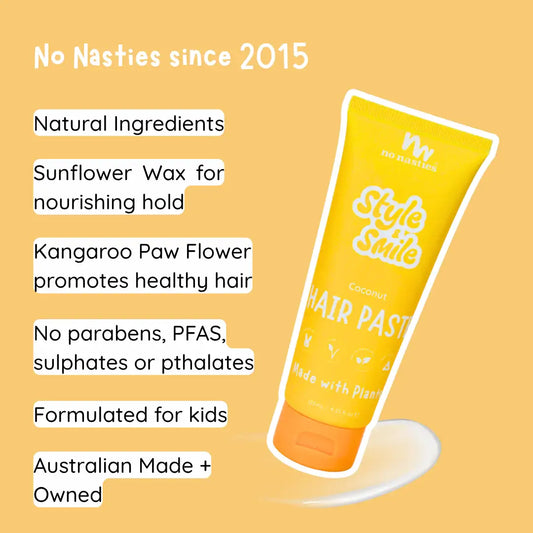 Hand holding a tube of No Nasties Style and Smile hair paste against a yellow background