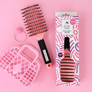 pink detangler brush on pink background with kids bag