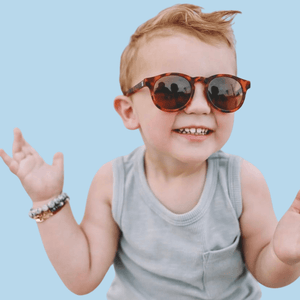 little boy wearing tortoise shell polarised sunglasses
