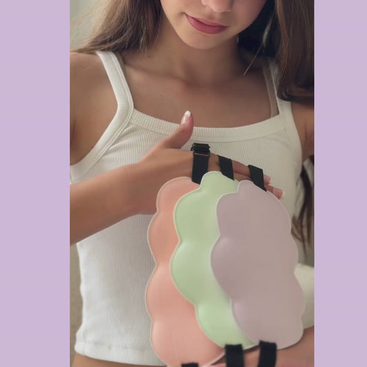 Girl wearing a pink sleep mask with a neutral background