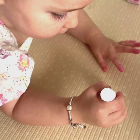 Little girl painting her nails on the carpet
