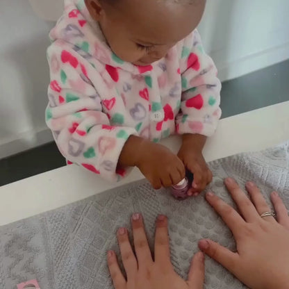 Little girl painting pink nails