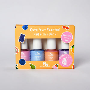 A boxed set of four fruit scented nail polishes in a bright orange package with fruit illustrations and pink callout stickers. The visible bottles are pink, blue, coral/orange, and purple, with the brand name 'no nasties' printed on the front.
