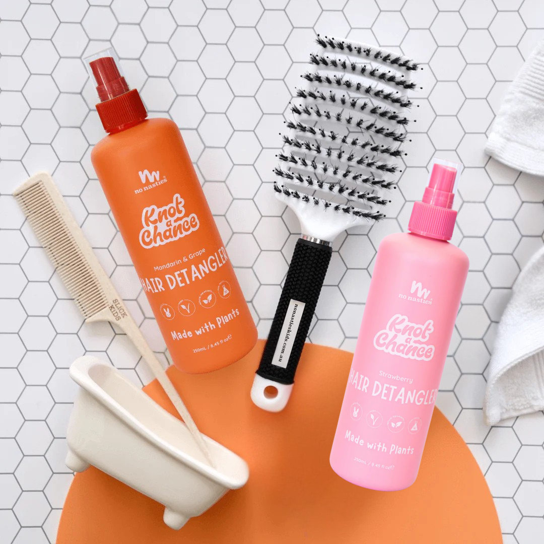 Two hair detangling products with tools on a tiled surface