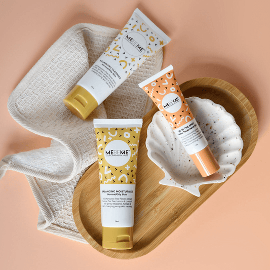 Three MEBEME skincare products on a bathroom shelf with a tiled wall background.
