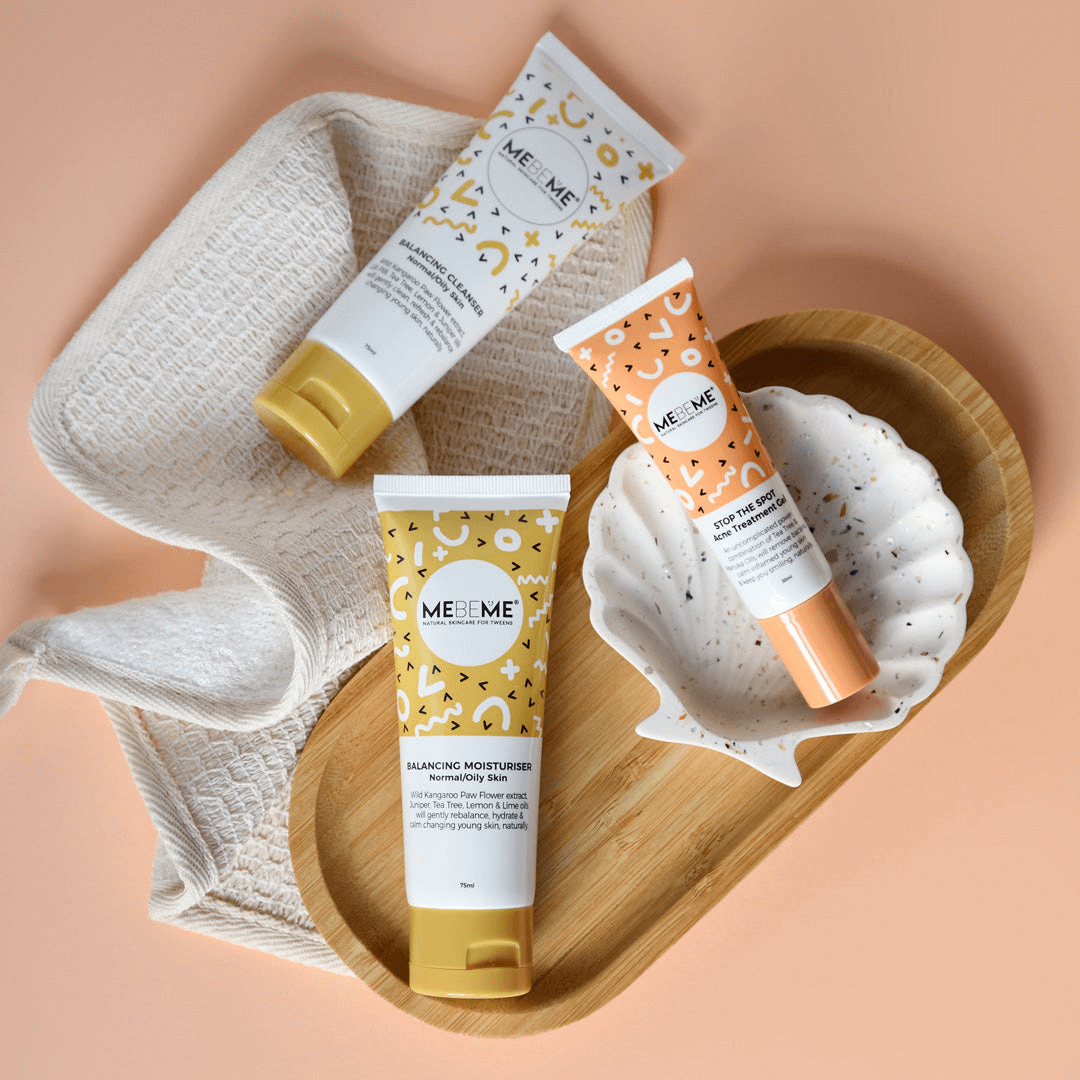 Three MEBEME skincare products on a bathroom shelf with a tiled wall background.