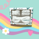 Skincare headband and dry cuff set packaging on a colourful background with rainbow, heart, and flower illustrations.