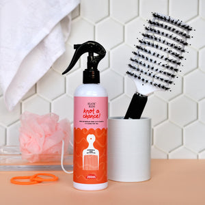 Natural plant based hair detangler and hair brush in bathroom