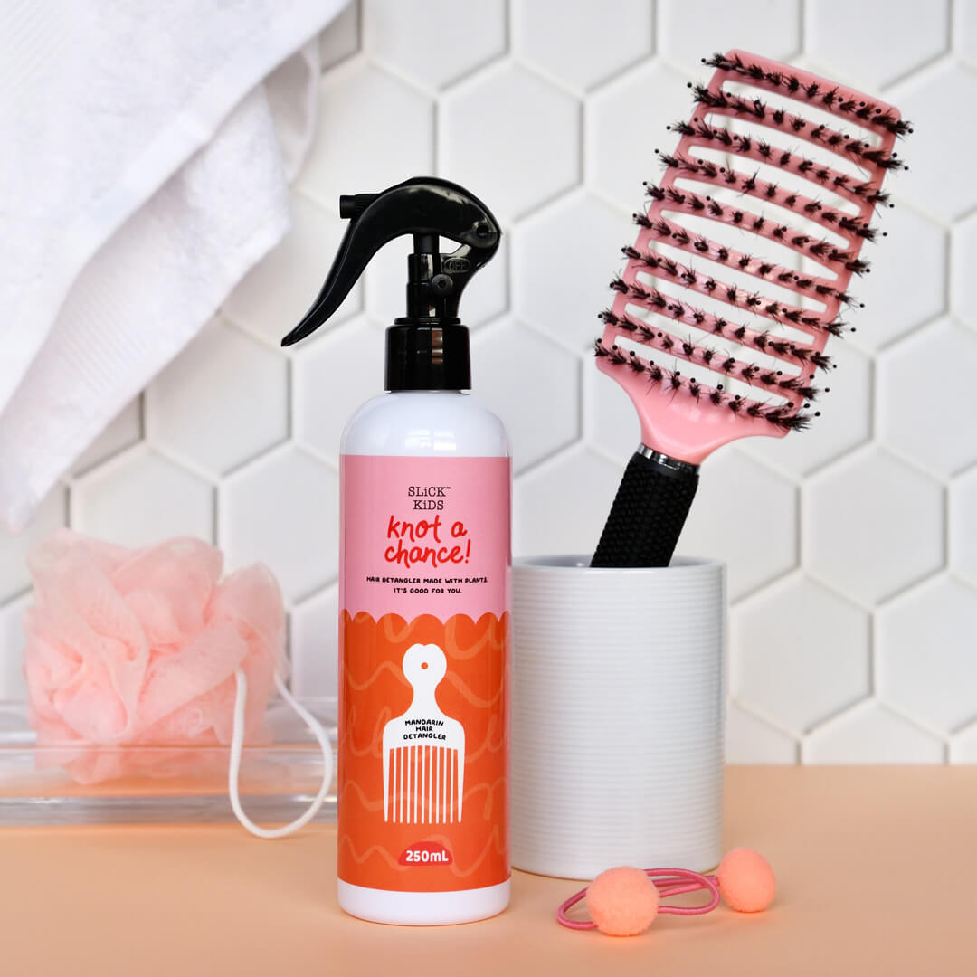 Natural plant based hair detangler and hair brush in bathroom