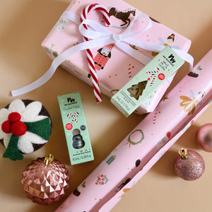Candy Cane Lip gloss and nail polish with pink Christmas wrapping paper