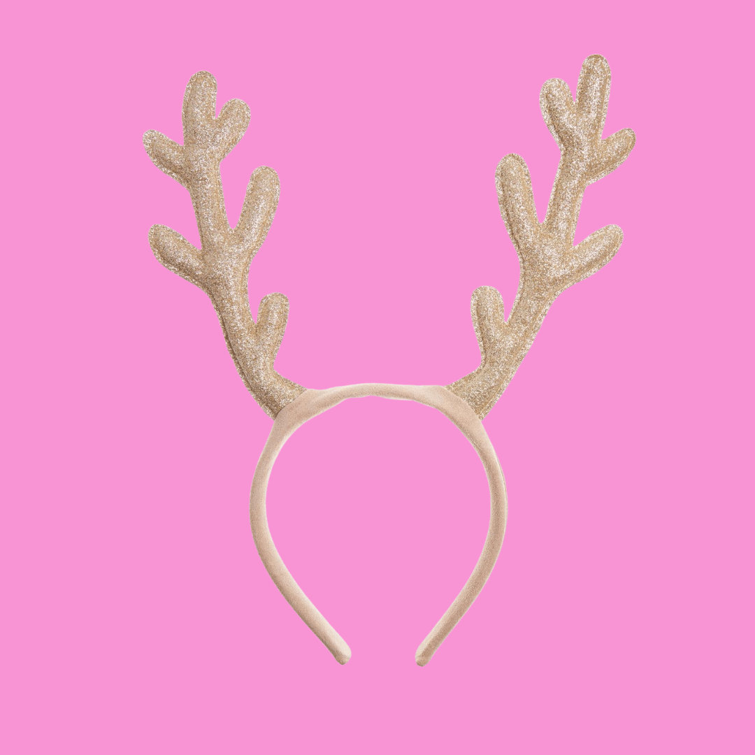 Little girl wearing sparkly reindeer antler headband