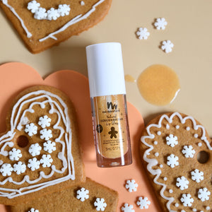 Gingerbread lipgloss with cookies in the back ground