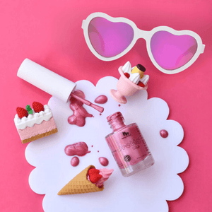 hot-pink-kids-nail-polish-with-heart-shaped-sunglasses-flat-lay