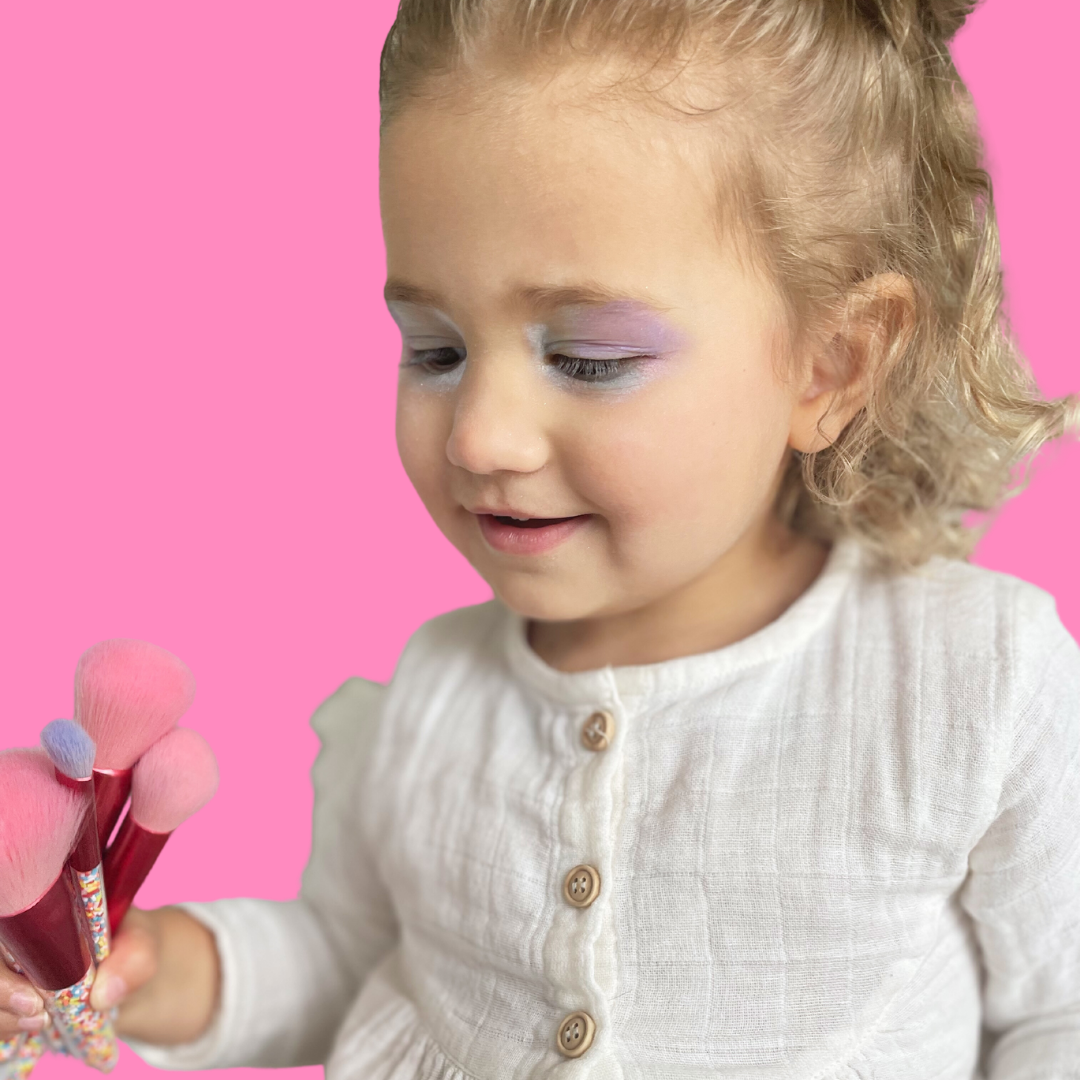 little-girl-playing-with-makeup-brushes