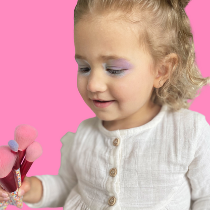little-girl-playing-with-makeup-brushes