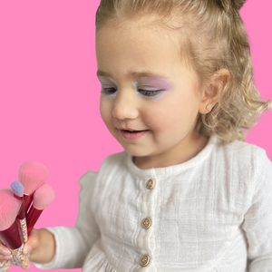 little-girl-playing-with-makeup-brushes