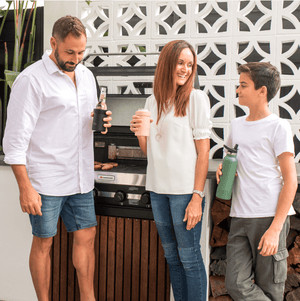 Family enjoying bbq using can and bottle cooler and drink bottle by Montii NZ