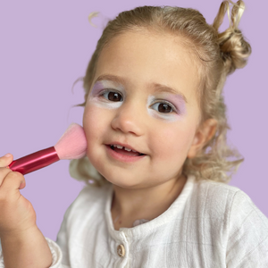 girl-playing-with-makeup-and-makeup-brushes