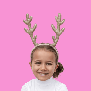 Little girl wearing sparkly reindeer antler headband